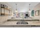 Stylish kitchen with marble countertops and stainless steel sink overlooking the cozy living spaces at 8 Lagoon Villas, Isle of Palms, SC 29451