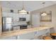 Charming kitchen featuring stainless steel appliances, marble countertops, and bright pendant lighting at 8 Lagoon Villas, Isle of Palms, SC 29451