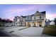 Beautiful townhomes showcasing architectural details, private driveways, and a landscaped lawn at 814 Alma Square Dr, Moncks Corner, SC 29461
