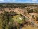 Wide aerial shot highlights property in its neighborhood with tree lined boundary, streets and a vibrant forest backdrop at 835 Gross Ave, Moncks Corner, SC 29461