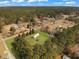 Property aerial shows home surrounded by nature with a lush lawn and towering trees providing both privacy and beauty at 835 Gross Ave, Moncks Corner, SC 29461