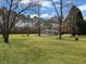 A charming home surrounded by a lush green lawn and mature trees, creating a serene and private setting at 835 Gross Ave, Moncks Corner, SC 29461