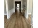 Hallway features clean lines, wainscoting, fresh paint and luxury vinyl plank flooring at 8620 Ashton Rd, Lodge, SC 29082