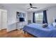 Cozy bedroom with blue bedding, dresser with TV, a ceiling fan and a window with blinds at 87 Ashley Hall Plantation Rd # 108, Charleston, SC 29407