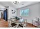 Bright dining room with modern decor, white chairs and wood-look flooring at 87 Ashley Hall Plantation Rd # 108, Charleston, SC 29407