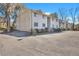 View of the front exterior of this neutral townhome with adjacent parking at 87 Ashley Hall Plantation Rd # 108, Charleston, SC 29407