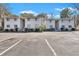 View of the front exterior of this neutral townhome with adjacent parking at 87 Ashley Hall Plantation Rd # 108, Charleston, SC 29407