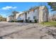 Neutral exterior townhome with well-maintained landscaping and adjacent parking lot at 87 Ashley Hall Plantation Rd # 108, Charleston, SC 29407