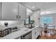Bright kitchen featuring stone counters, stainless appliances and fixtures, with wood-look flooring at 87 Ashley Hall Plantation Rd # 108, Charleston, SC 29407