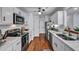 Updated kitchen with white cabinets, stainless steel appliances, and wood-look floors at 87 Ashley Hall Plantation Rd # 108, Charleston, SC 29407