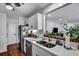 Well-lit kitchen with stone countertops, stainless appliances, and wood-look floors at 87 Ashley Hall Plantation Rd # 108, Charleston, SC 29407