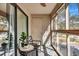 Enclosed sunroom with a view, seating area, and plant life that create a calming atmosphere at 87 Ashley Hall Plantation Rd # 108, Charleston, SC 29407