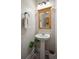 Chic pedestal sink bathroom featuring a framed mirror, modern fixtures, and stylish decor at 8816 Kellum Dr, North Charleston, SC 29420