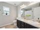 Bright bathroom with a double sink vanity, tile floors and natural light from a window at 8816 Kellum Dr, North Charleston, SC 29420