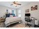 Cozy bedroom with a ceiling fan, natural light, and adjacent desk area at 8816 Kellum Dr, North Charleston, SC 29420