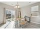 Sunlit dining area with access to the patio through sliding glass doors and minimalist decor at 8816 Kellum Dr, North Charleston, SC 29420