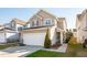 Two-story home with a two-car garage, a basketball hoop, and manicured landscaping at 8816 Kellum Dr, North Charleston, SC 29420