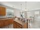 Bright kitchen with a center island, wooden cabinets, and modern stainless appliances at 8816 Kellum Dr, North Charleston, SC 29420
