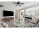 Bright living room with modern decor, ceiling fan, and hardwood floors, offering a cozy and stylish space at 8816 Kellum Dr, North Charleston, SC 29420