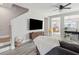 Open-concept living room with hardwood floors, modern entertainment center, and staircase access at 8816 Kellum Dr, North Charleston, SC 29420