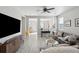Bright living room featuring hardwood floors, large sofa, modern entertainment center, and stylish decor at 8816 Kellum Dr, North Charleston, SC 29420