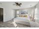 Bright bedroom with a large bed, ceiling fan, patterned rug, and ample natural light at 8816 Kellum Dr, North Charleston, SC 29420