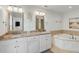 Bathroom featuring double vanity sinks, granite countertop, whirlpool tub, and stylish fixtures at 9 J C Long Blvd, Isle of Palms, SC 29451