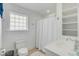 Bright white bathroom with a shower, window and tile flooring offers a clean and modern aesthetic at 9 J C Long Blvd, Isle of Palms, SC 29451