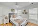Bright bedroom with a ceiling fan, natural light, and beautiful wood floors at 9 J C Long Blvd, Isle of Palms, SC 29451