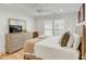 Cozy bedroom with wood floors, a ceiling fan, and a window with bright, natural light at 9 J C Long Blvd, Isle of Palms, SC 29451