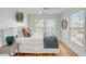 Cozy bedroom with a large bed, wooden floors, and two windows provides a relaxing and inviting space at 9 J C Long Blvd, Isle of Palms, SC 29451