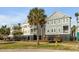 Street view of two-story homes with palm trees and black metal fences at 9 J C Long Blvd, Isle of Palms, SC 29451