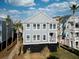 Two-story home with gray siding and a small front porch at 9 J C Long Blvd, Isle of Palms, SC 29451