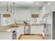 Well-lit kitchen featuring white cabinets, granite counters, and stainless appliances at 9 J C Long Blvd, Isle of Palms, SC 29451