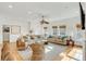 Open-concept living area with plush sofas, woven chairs, and views of the neighborhood and windows at 9 J C Long Blvd, Isle of Palms, SC 29451