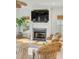Cozy fireplace featuring woven chairs and a ceiling fan near large bright windows at 9 J C Long Blvd, Isle of Palms, SC 29451