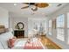 Bright main bedroom with ceiling fan and sitting area next to a sunny window at 9 J C Long Blvd, Isle of Palms, SC 29451