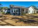 Well-maintained backyard offering a cozy screened porch and a charming outdoor seating arrangement at 103 Noisette Row, Summerville, SC 29483