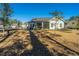 Expansive backyard featuring a screened porch and an outdoor seating area for relaxation and entertainment at 103 Noisette Row, Summerville, SC 29483