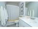 Bright bathroom with marble countertop and striped shower curtain at 103 Noisette Row, Summerville, SC 29483