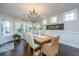 Bright dining room with a large wooden table and views of the landscaped backyard at 103 Noisette Row, Summerville, SC 29483