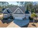Front exterior showcasing a two-car garage, with a blend of stone and vinyl at 103 Noisette Row, Summerville, SC 29483