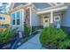 Charming home featuring a stone facade and a welcoming front porch with tasteful landscaping at 103 Noisette Row, Summerville, SC 29483