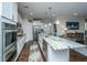Modern kitchen featuring white cabinetry, stainless steel appliances, and a marble island at 103 Noisette Row, Summerville, SC 29483