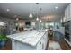 Open kitchen with a spacious island, stainless steel appliances and hardwood floors at 103 Noisette Row, Summerville, SC 29483