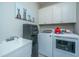 A functional laundry room with white cabinets and modern appliances at 103 Noisette Row, Summerville, SC 29483