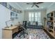 Well-lit home office featuring built-in bookshelves and comfortable seating at 103 Noisette Row, Summerville, SC 29483