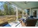 Comfortable screened porch with wicker furniture and serene backyard views at 103 Noisette Row, Summerville, SC 29483