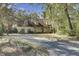 Traditional home featuring a welcoming front porch and a driveway, nestled among mature trees and green spaces at 1042 Chambers Ln, Mount Pleasant, SC 29464