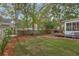 Large backyard with a wooden deck area that has outdoor furniture surrounded by a privacy fence and mature trees at 105 Carter Dr, Goose Creek, SC 29445